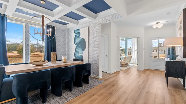 a living room with furniture and a mirror