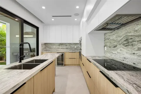 a kitchen with stainless steel appliances granite countertop a sink and a stove