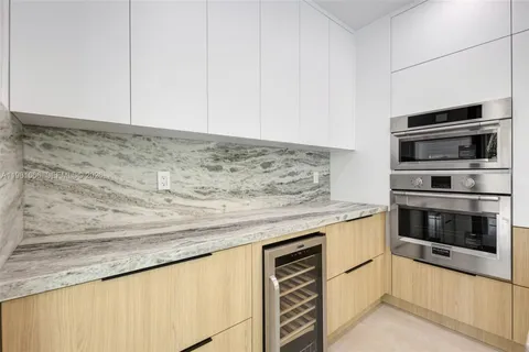a kitchen with granite countertop cabinets stainless steel appliances and sink