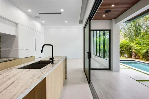 a kitchen with a sink and a large window
