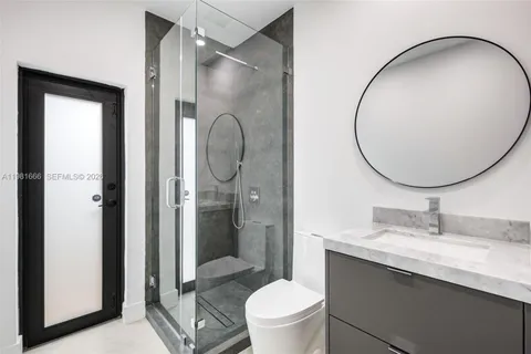 a bathroom with a sink a toilet and a mirror