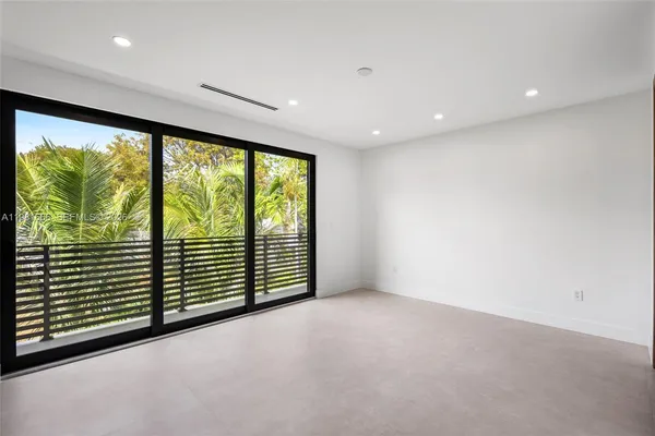 a view of an empty room with a large window