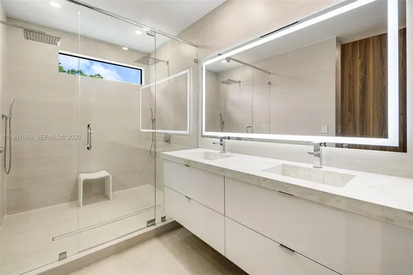 a bathroom with a double vanity sink and a mirror