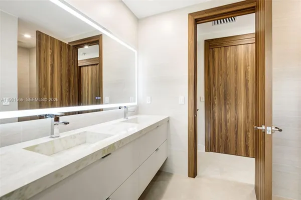 an empty room with closet and a bathroom