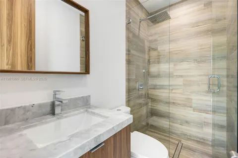 an empty room with closet and a bathroom