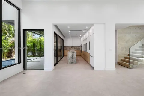 a view of a hallway with furniture and floor to ceiling window