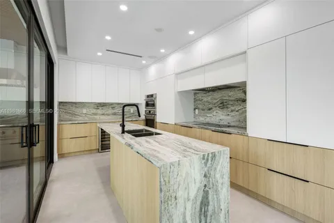 a view of kitchen with cabinets and outdoor space