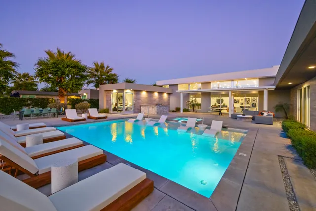 a view of a swimming pool with chairs