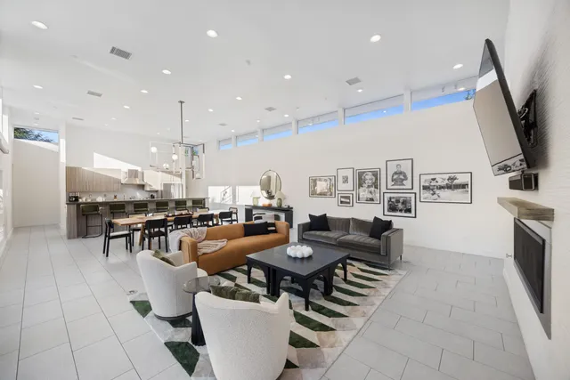 a living room with furniture and a potted plant
