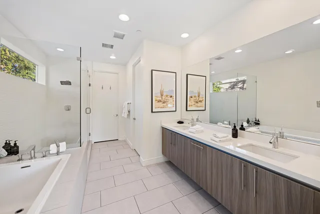 a bathroom with double sink and a mirror