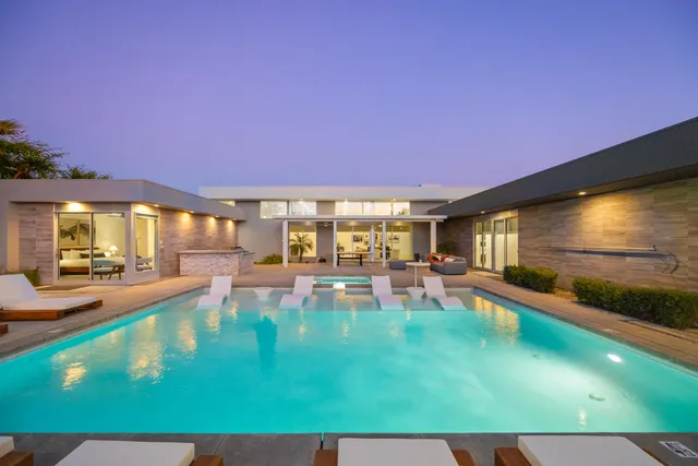 a view of a swimming pool with an outdoor seating and a yard