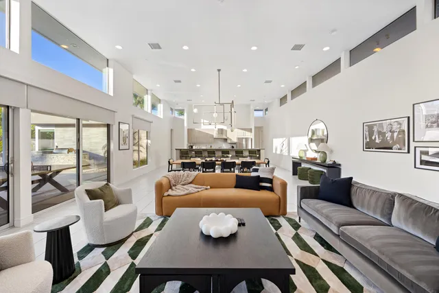 a living room with furniture and a view of kitchen