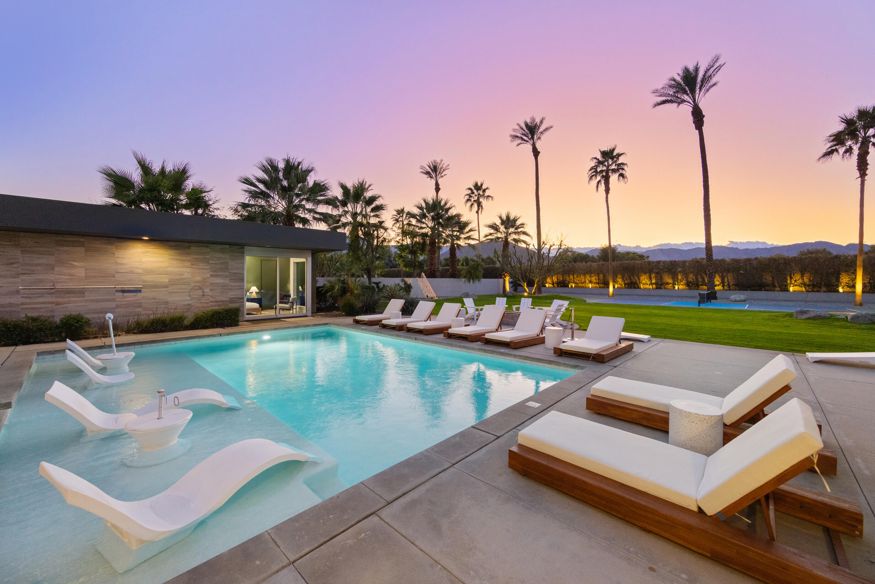 51165 Evangeline Way La Quinta, CA 92253 - Photo 34 of 48 a view of a swimming pool with a lounge chairs
