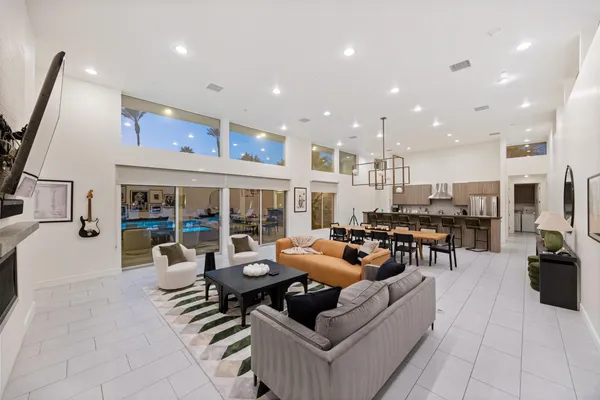 a kitchen with a sink and chairs