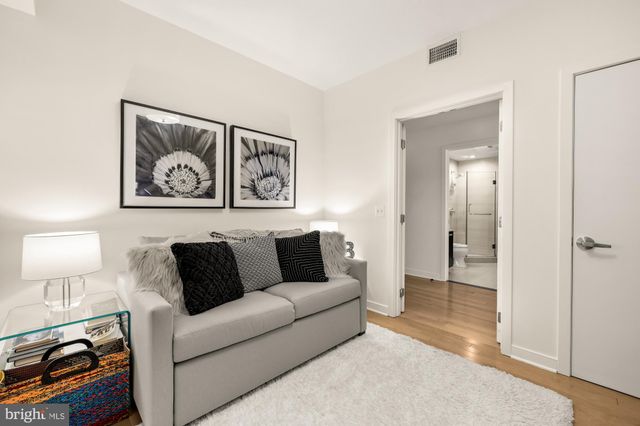 a living room with furniture and a lamp