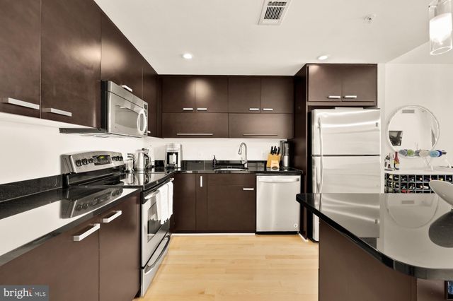 a kitchen with a refrigerator and a sink