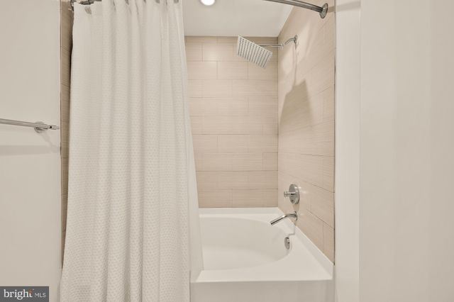 a bathroom with a shower and a bath tub