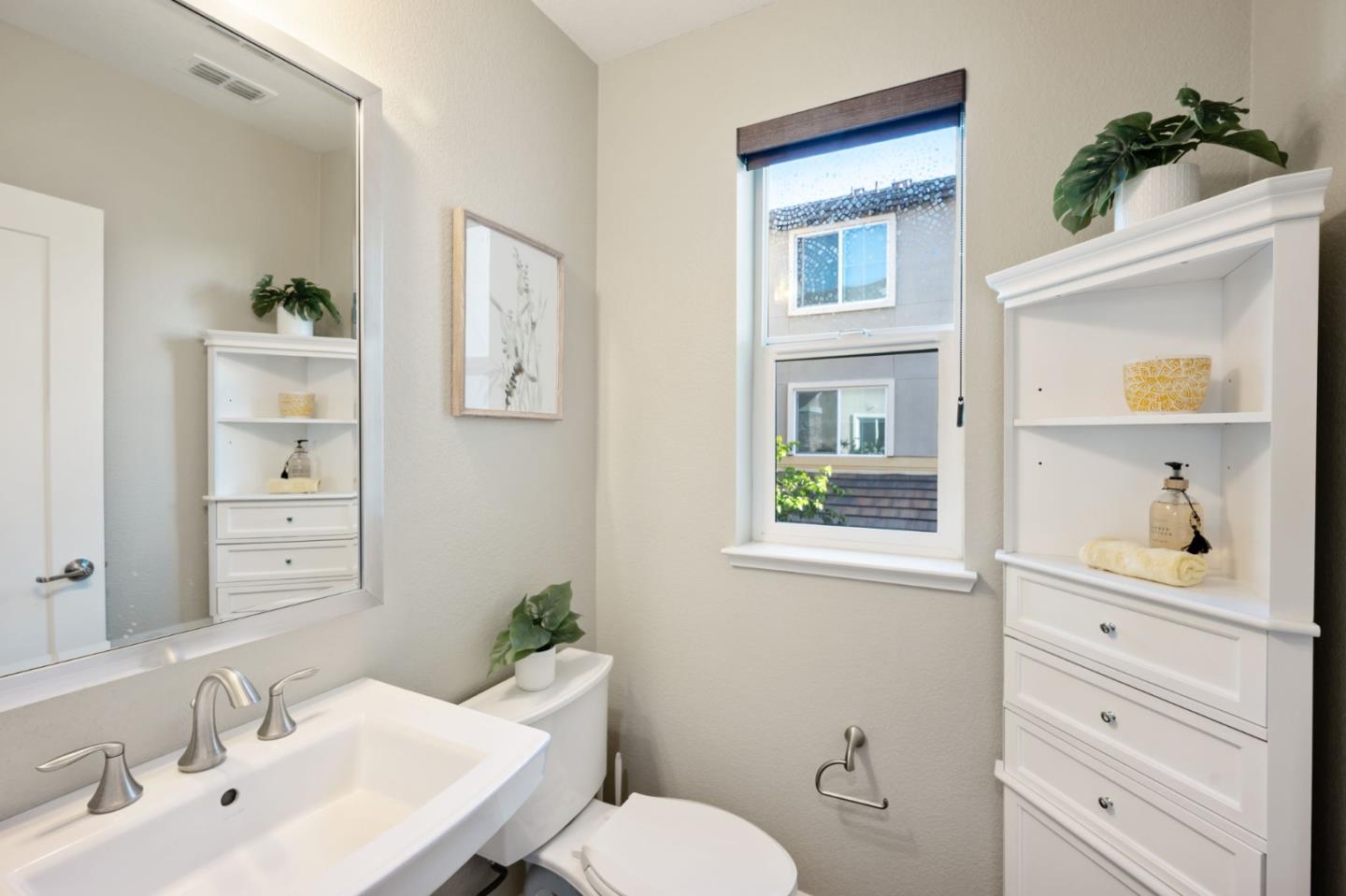5977 Larkstone Loop San Jose, CA 95123 - Photo 37 of 63 a bathroom with a toilet a sink and mirror