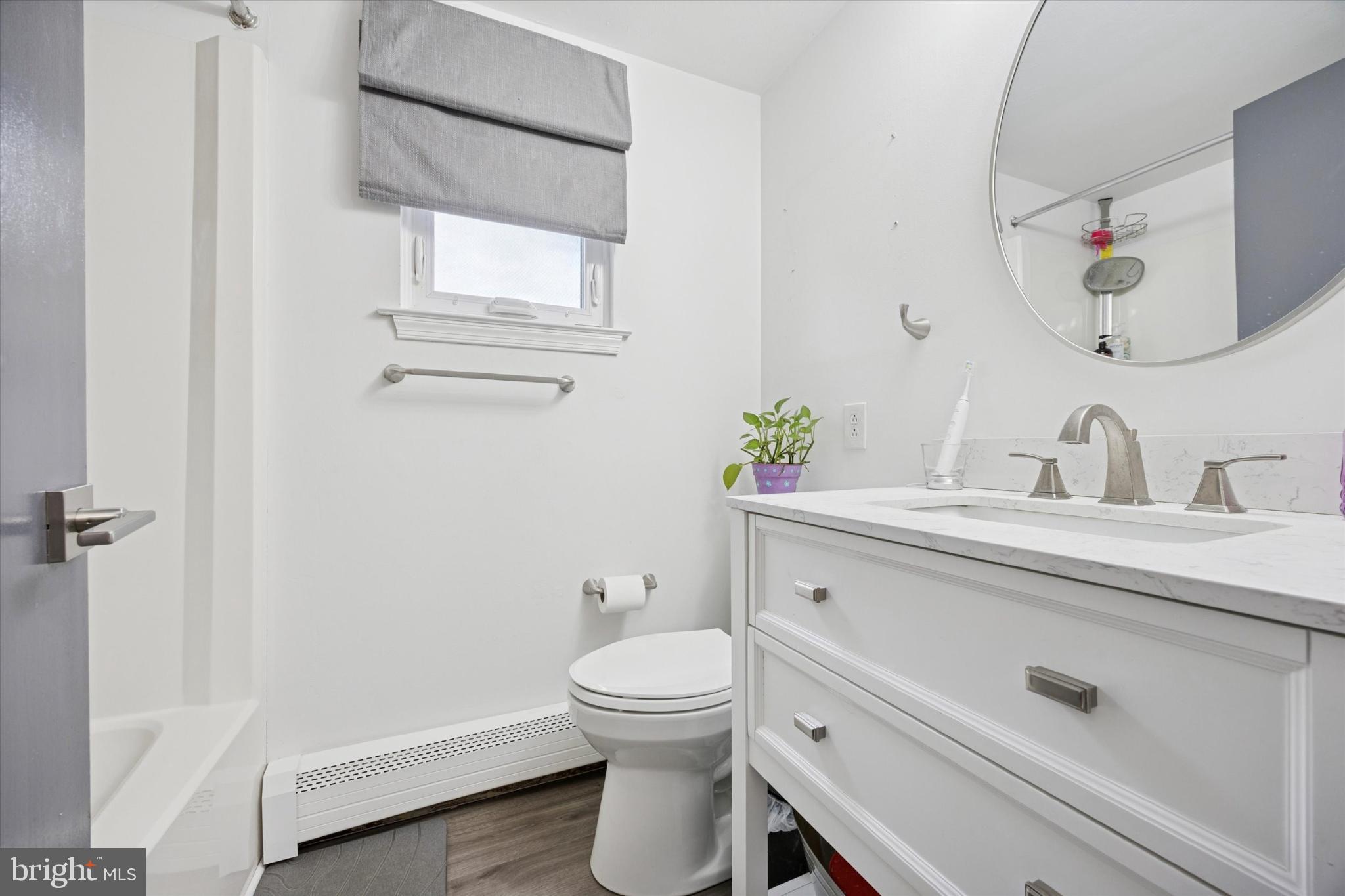 315 Oak Lane West Exton, PA 19341 - Photo 12 of 15 a bathroom with a sink a toilet and a mirror