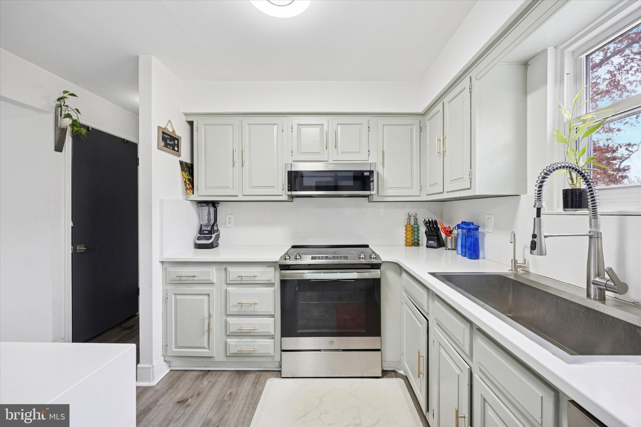 315 Oak Lane West Exton, PA 19341 - Photo 5 of 15 a kitchen with granite countertop a stove sink and refrigerator