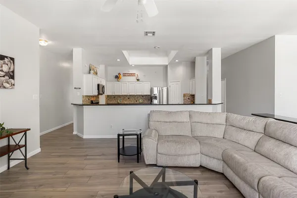 a living room with furniture and kitchen view