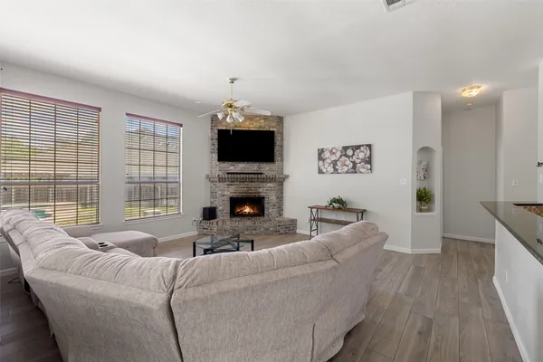a living room with furniture a fireplace and a flat screen tv