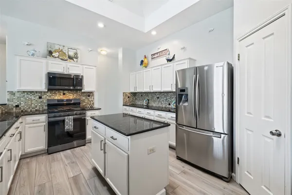 a kitchen with a refrigerator stove and microwave