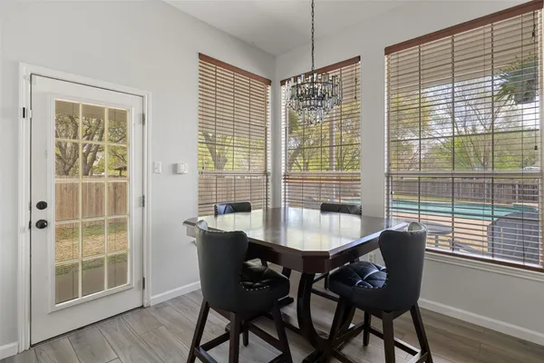 a dining room with furniture and wooden floor