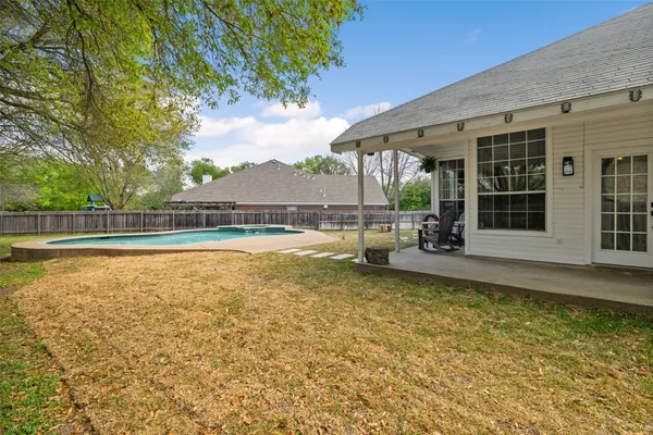 a view of a swimming pool with an outdoor seating