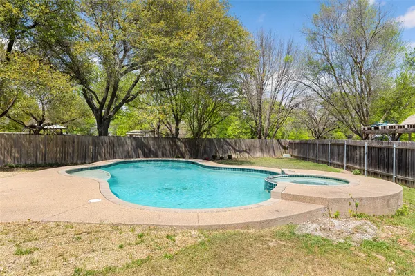 a view of a swimming pool with a yard