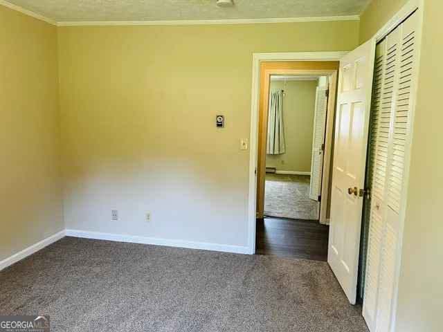 an empty room with wooden floor and a window
