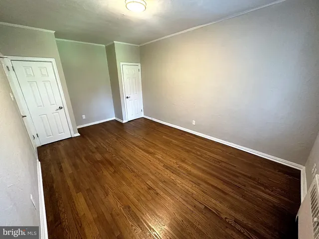an empty room with wooden floor