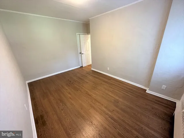 an empty room with wooden floor