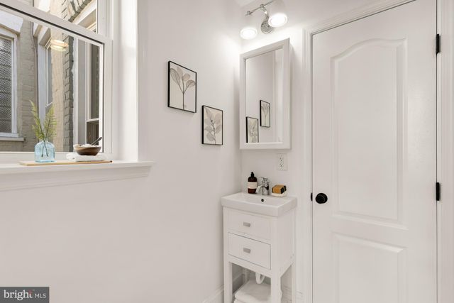 a bedroom with a large bed and large windows