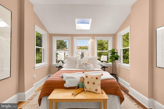 a living room with furniture a rug and a large window