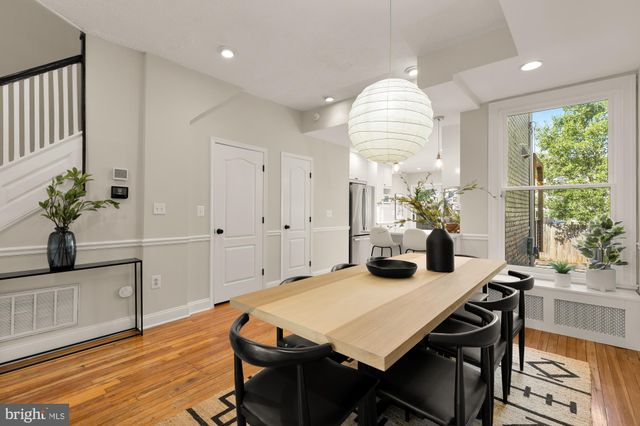a dining room with furniture and a chandelier