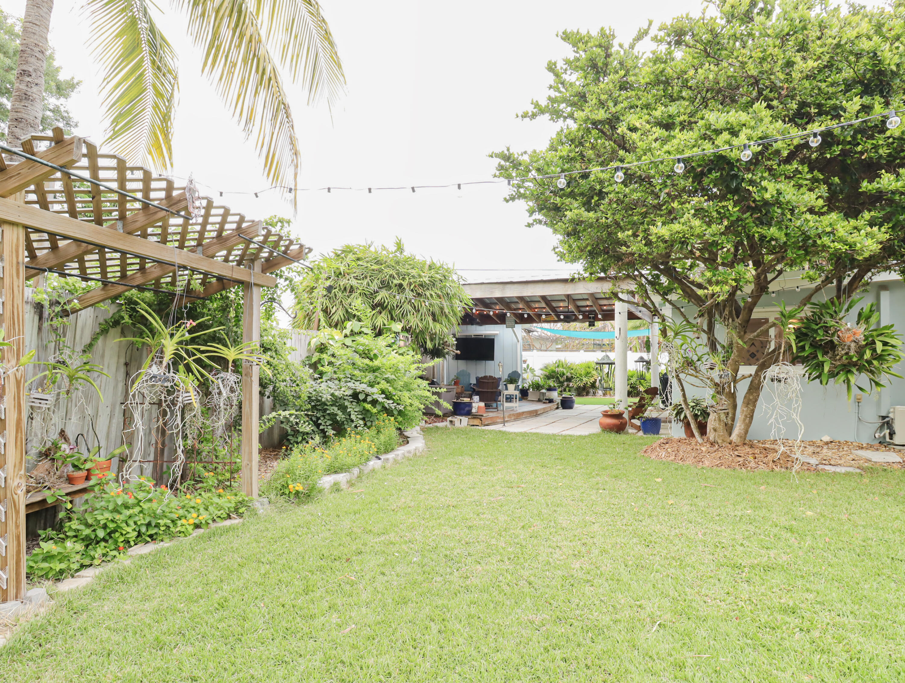160 Ridge Street Tavernier, FL 33070 - Photo 21 of 25 a view of a yard with table and chairs and potted plants