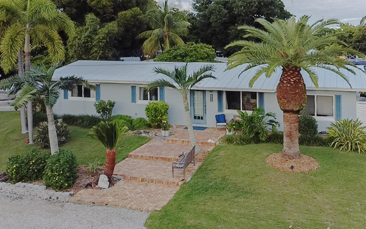 160 Ridge Street Tavernier, FL 33070 - Photo 24 of 25 a front view of a house with a garden