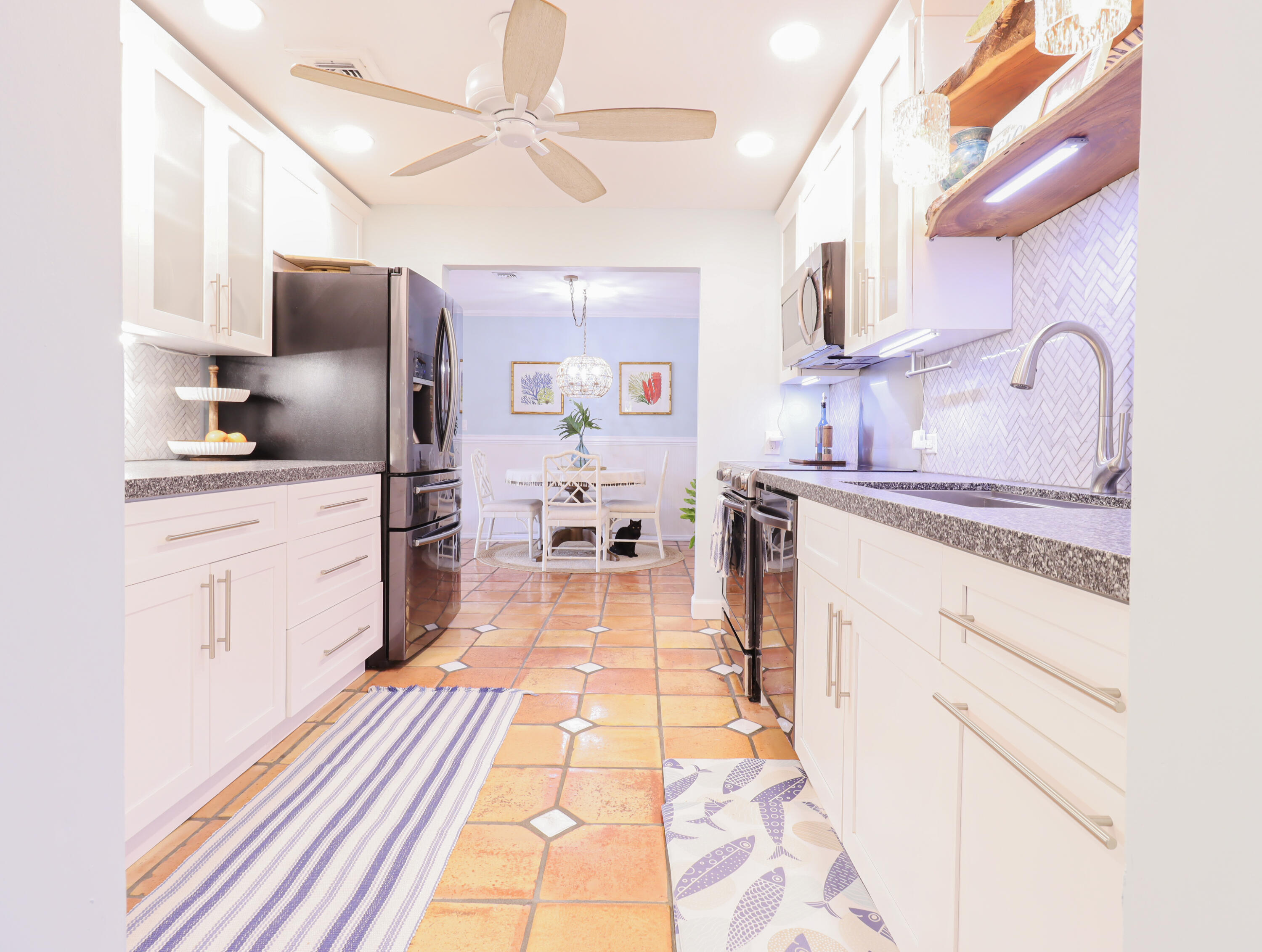 160 Ridge Street Tavernier, FL 33070 - Photo 8 of 25 a kitchen with stainless steel appliances granite countertop a sink dishwasher stove refrigerator and cabinets with wooden floor