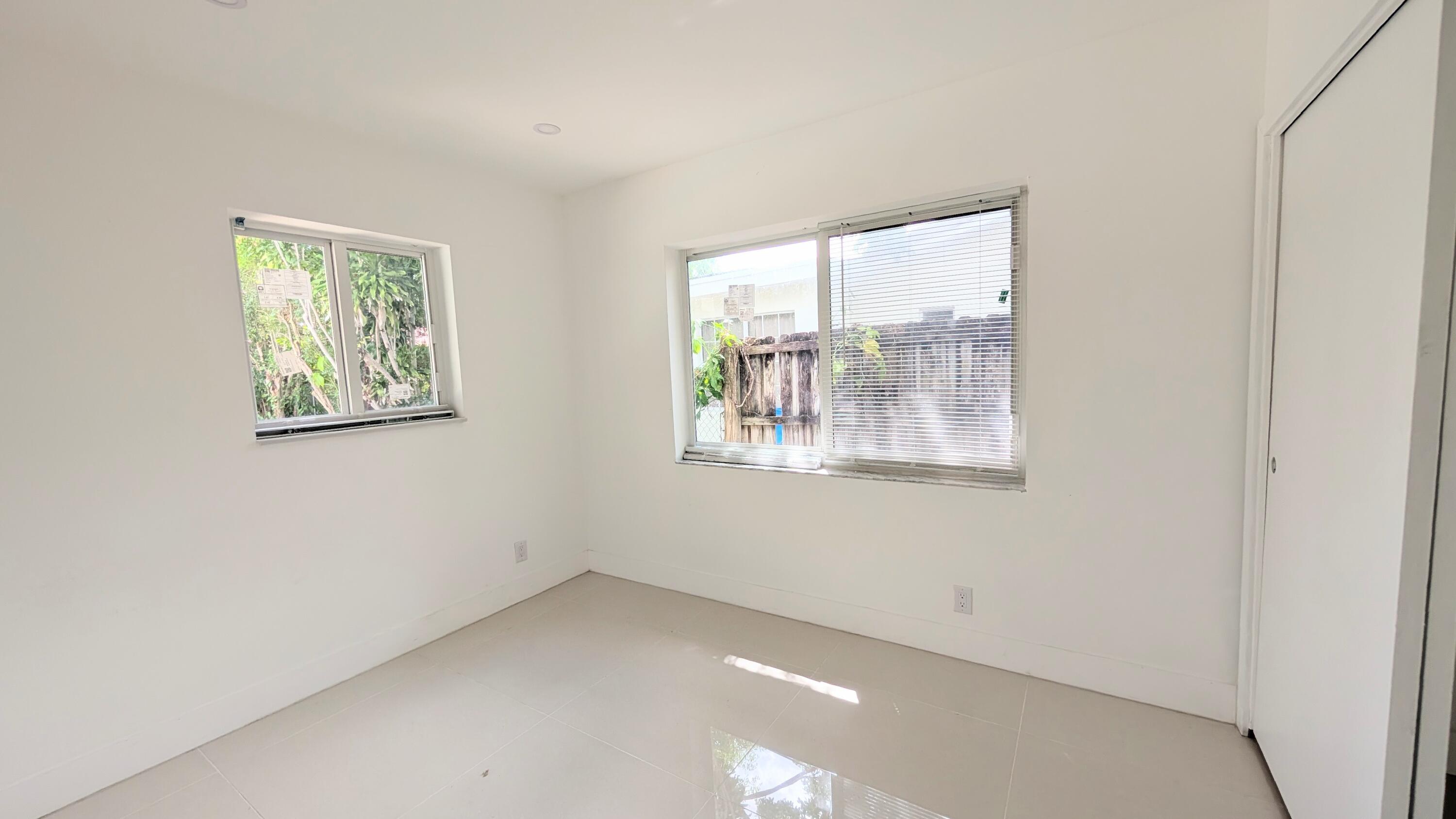 3840 Northeast 22nd Terrace Lighthouse Point, FL 33064 - Photo 11 of 18 an empty room with windows
