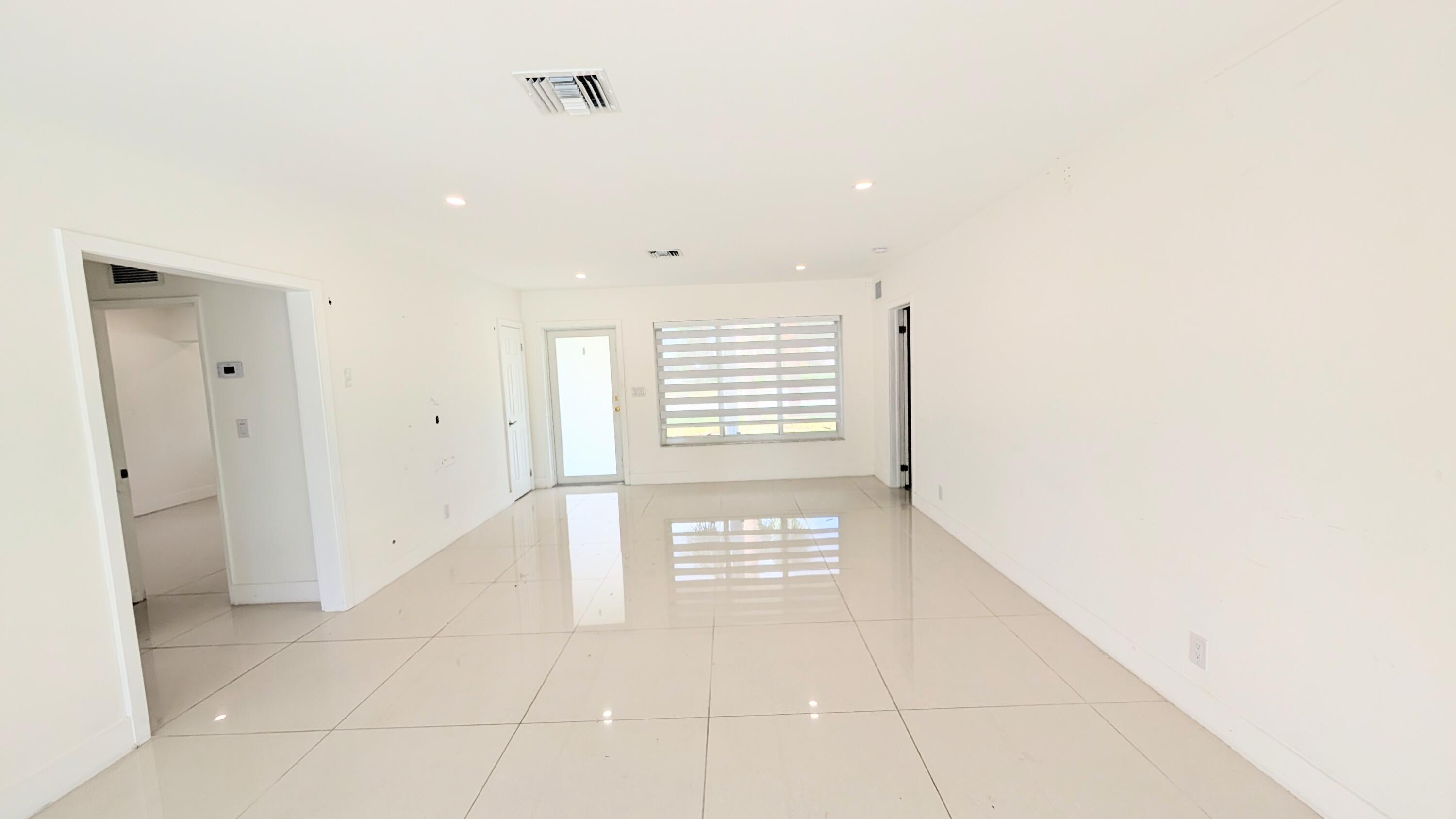 3840 Northeast 22nd Terrace Lighthouse Point, FL 33064 - Photo 13 of 18 a view of an empty room with a window