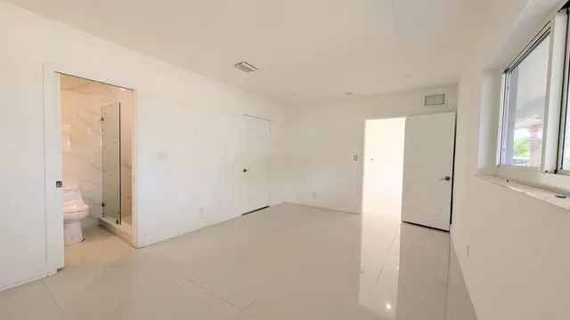 a view of room with windows and bathroom view