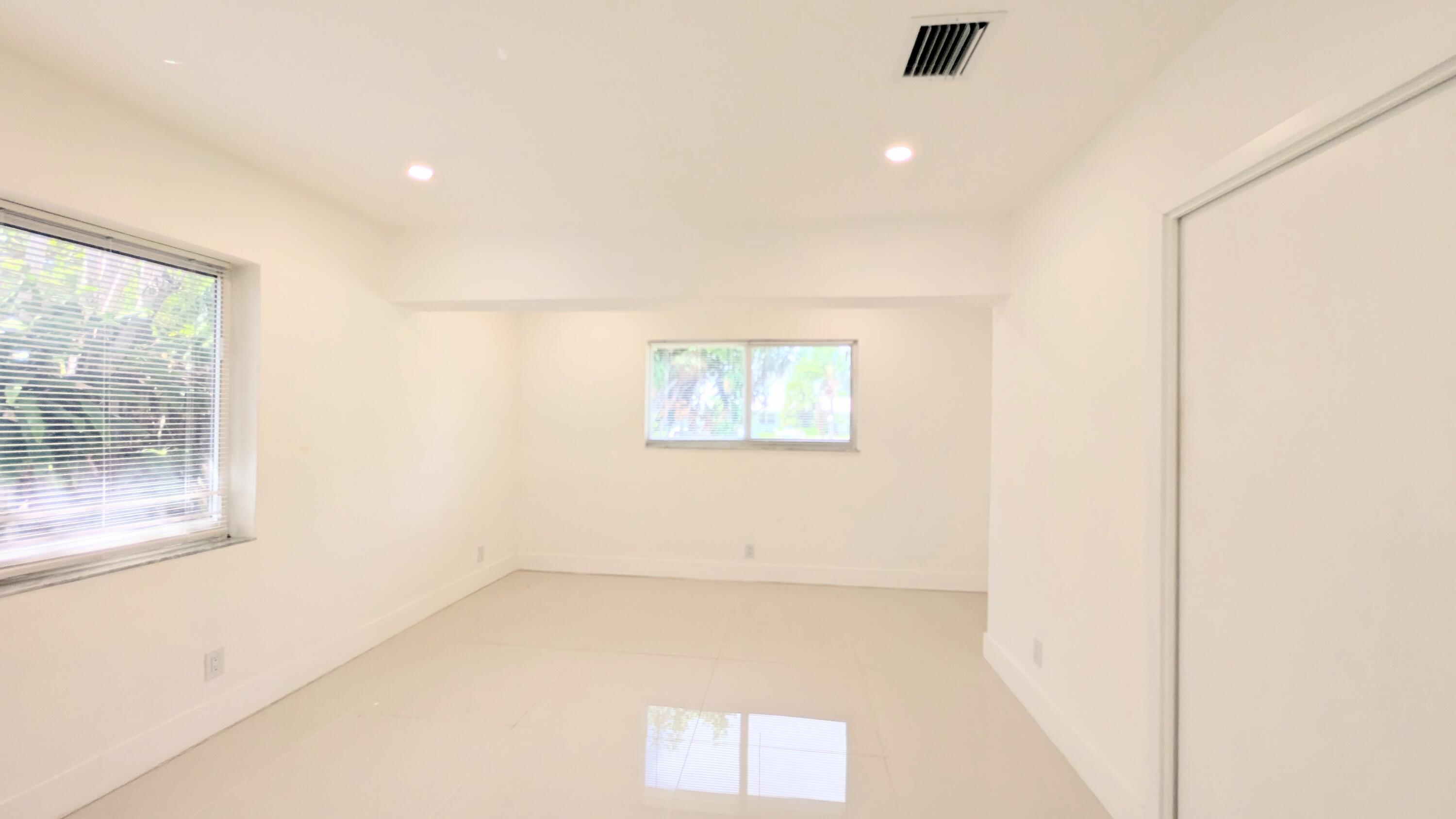 3840 Northeast 22nd Terrace Lighthouse Point, FL 33064 - Photo 8 of 18 a view of a big room with wooden floor and windows