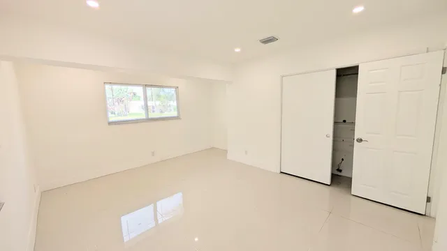 a view of an empty room with a window