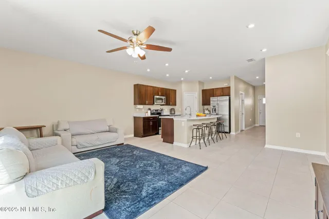 a living room with furniture and kitchen view