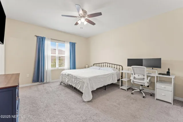 a spacious bedroom with a bed and a chandelier