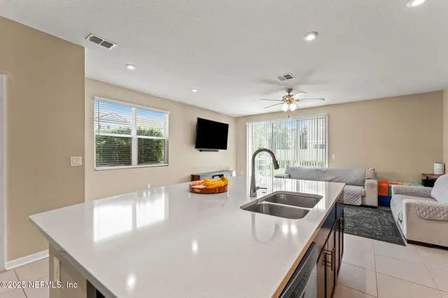 a kitchen with a sink and breakfast area