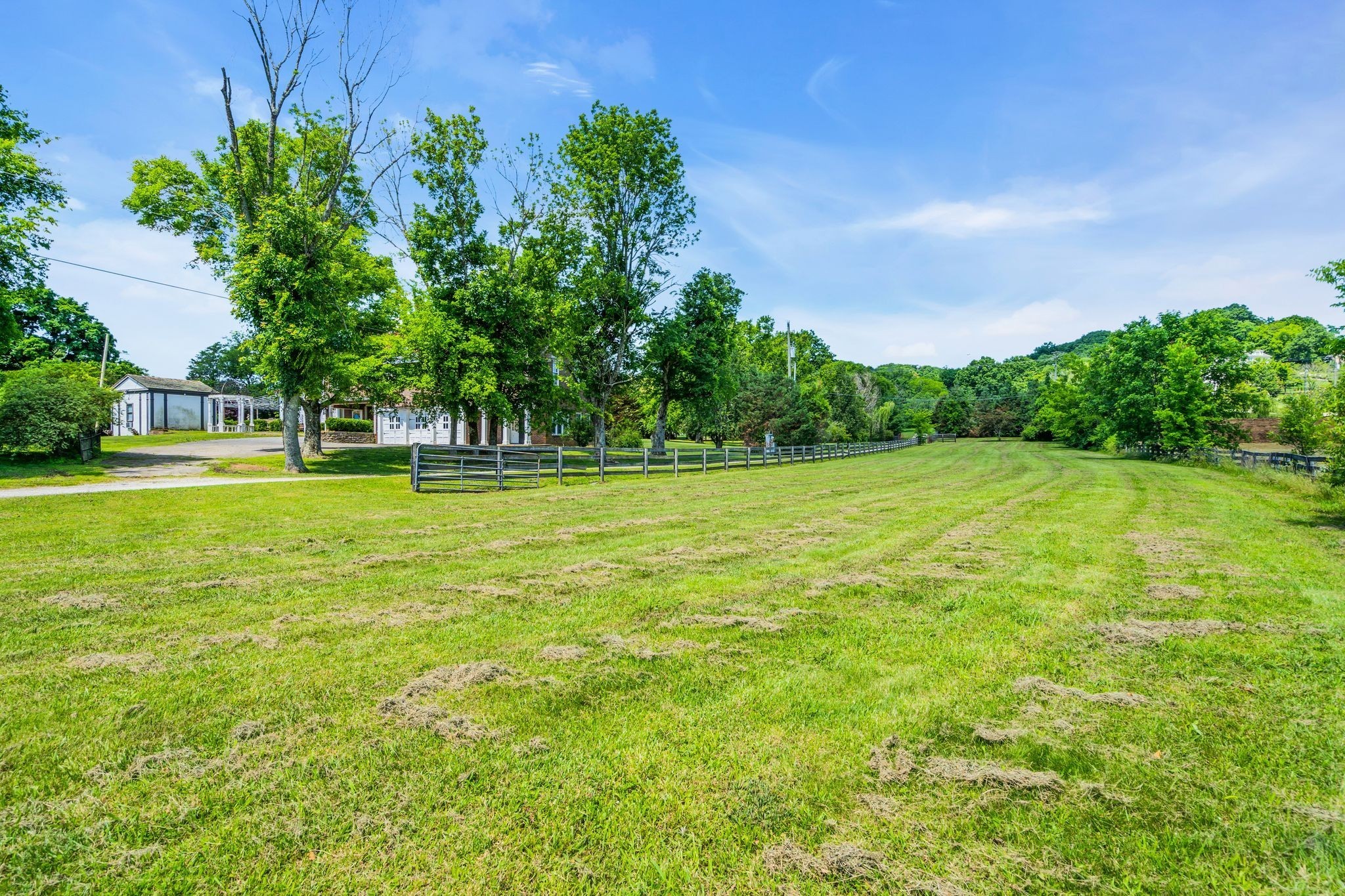 1112 Franklin Road Brentwood, TN 37027 - Photo 33 of 68 a view of a grassy field with trees in the background