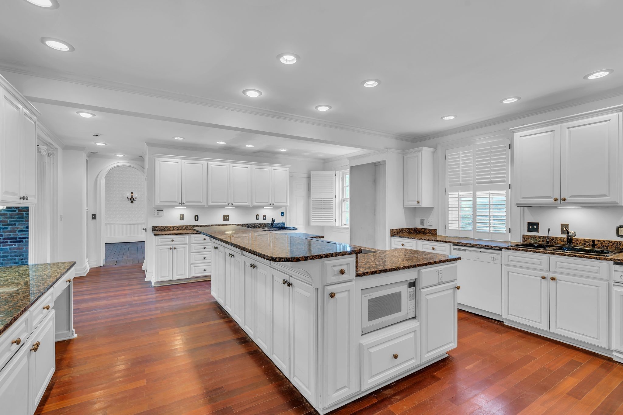 1112 Franklin Road Brentwood, TN 37027 - Photo 49 of 68 an open white kitchen with center island and stainless steel appliances
