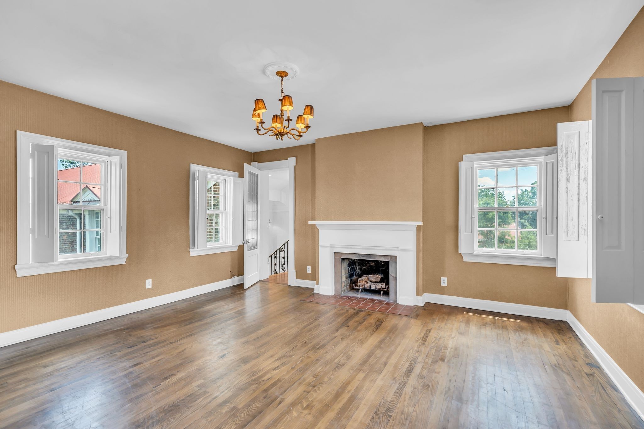 1112 Franklin Road Brentwood, TN 37027 - Photo 61 of 68 an empty room with windows a fireplace and wooden floor